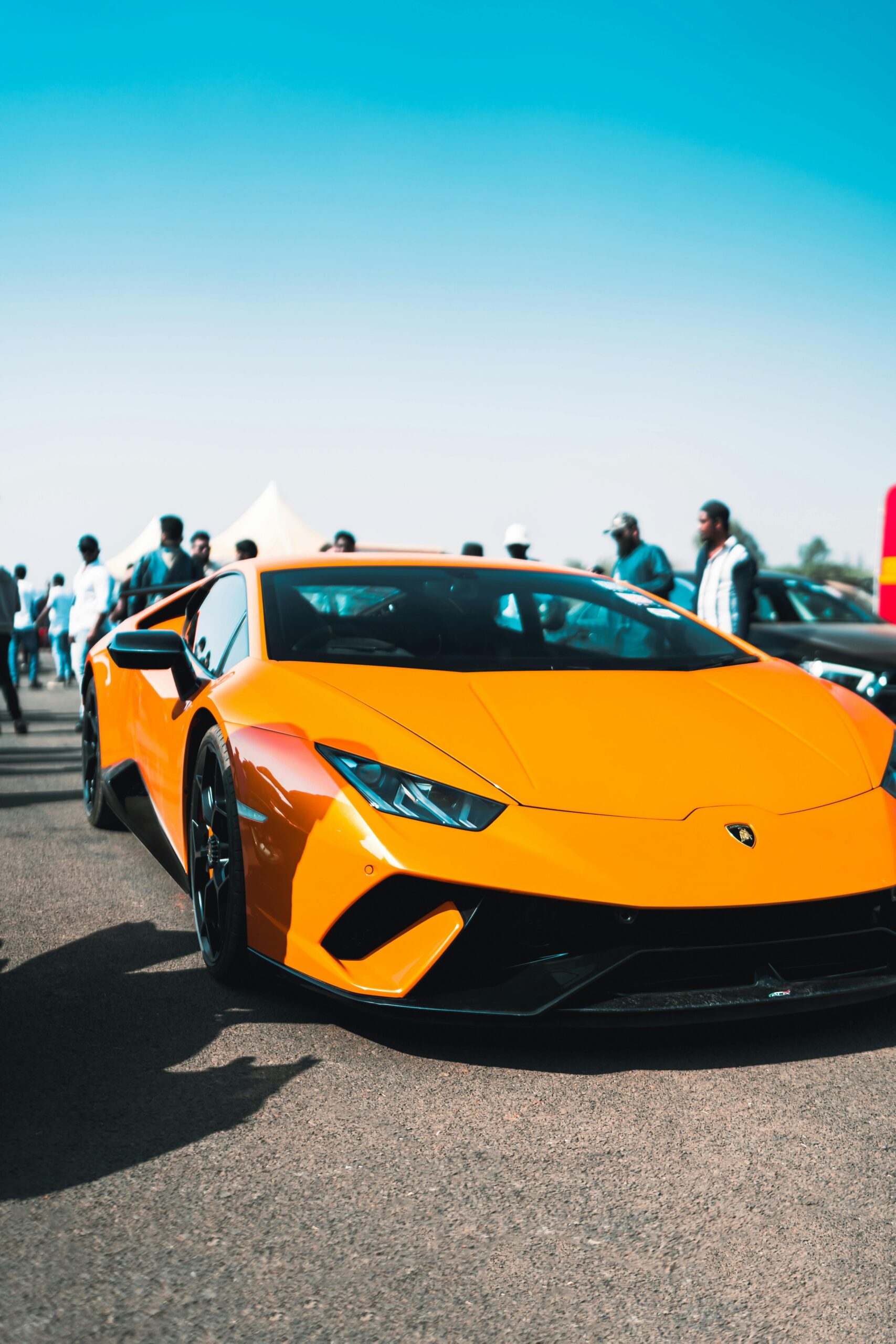 A striking yellow Lamborghini Aventador parked outdoors, showcasing luxury and style.